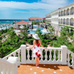 girl-in-hat-looking-on-sea-in-luxury-resort1